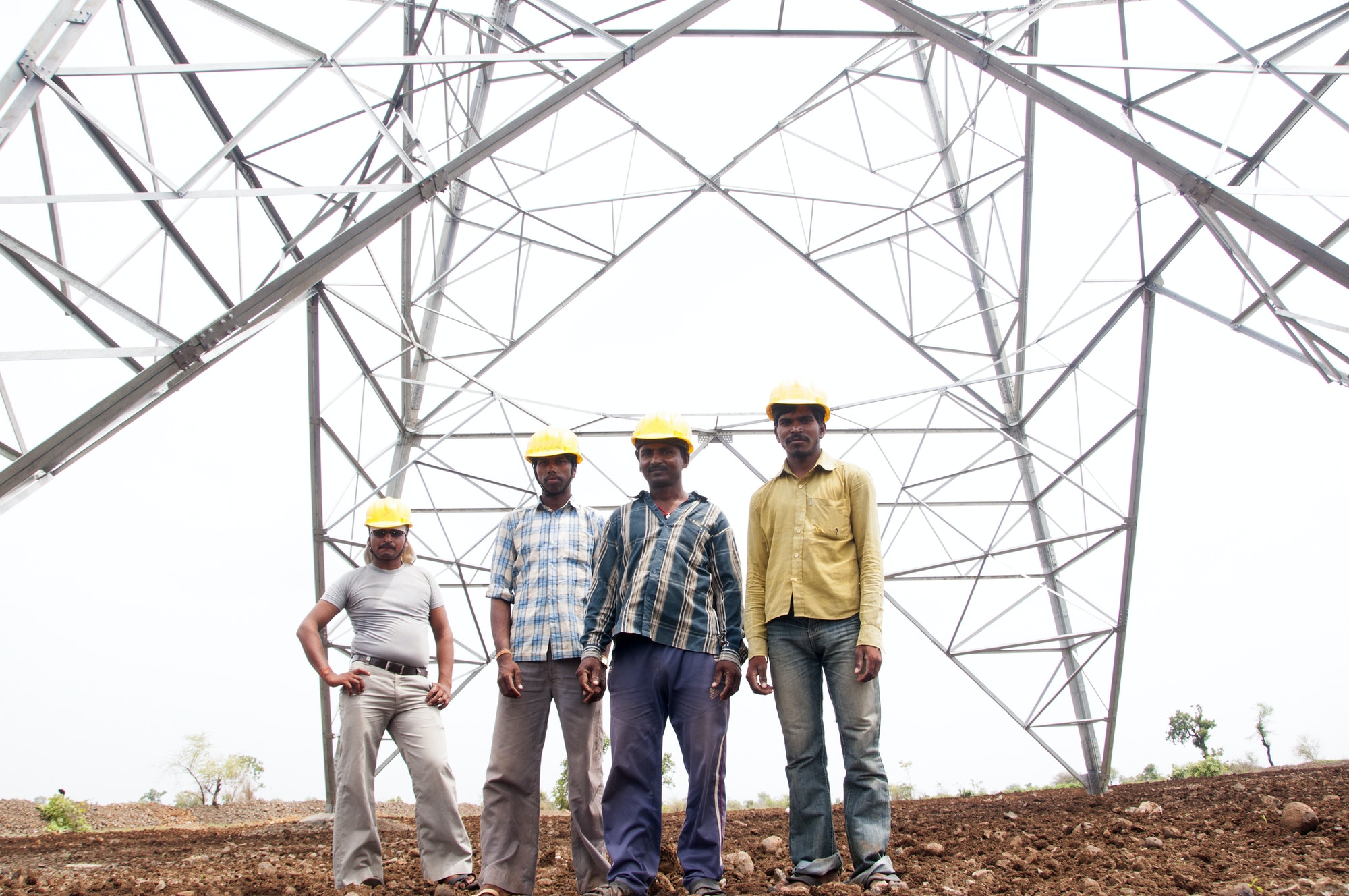 Portrait of Pylon construction workers, India.