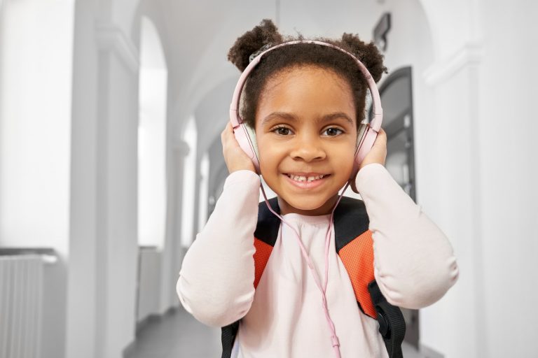Portrait of schoolgirl with headphones in school
