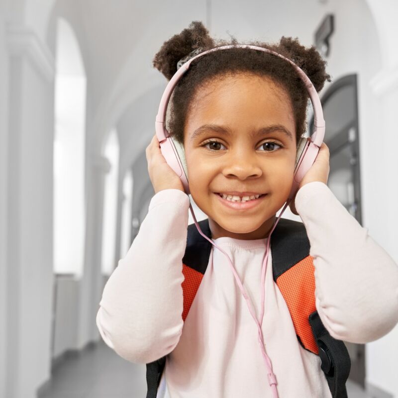 Portrait of schoolgirl with headphones in school