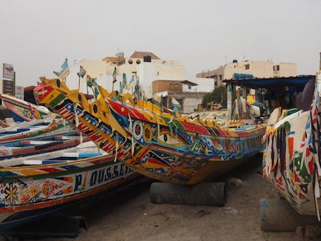 Colorful traditional fishing boats docked in a coastal harbor, reflecting local culture and artistry.